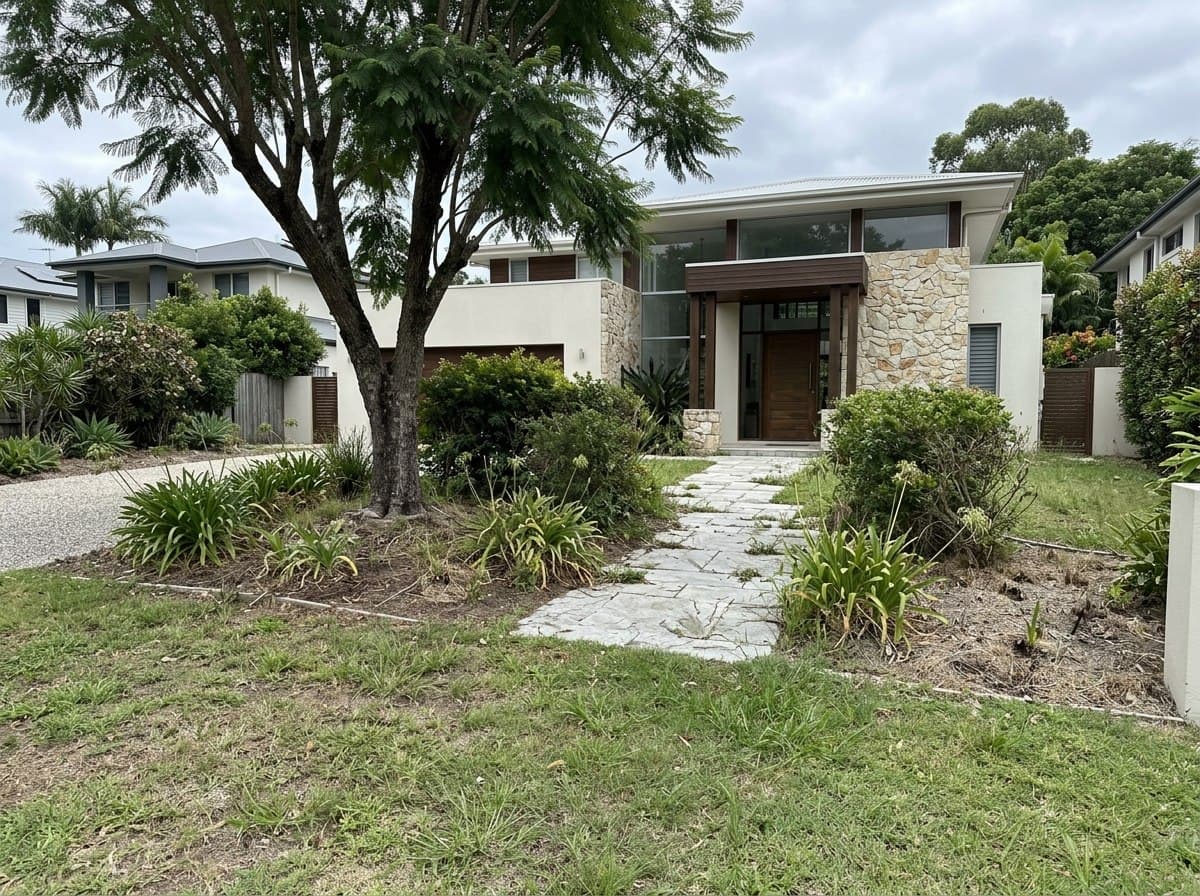 Tired Buderim front garden with patchy lawn and overgrown shrubs before rejuvenation