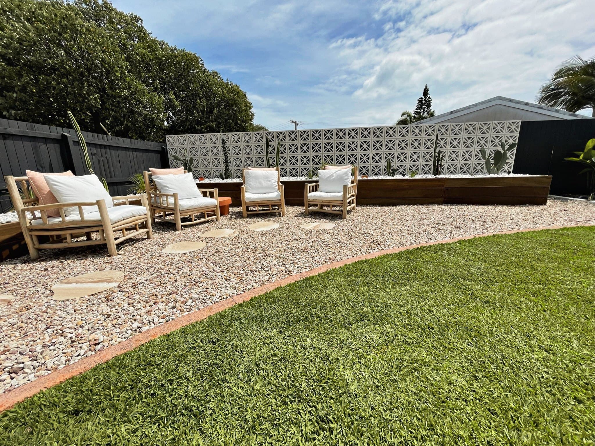 A completed courtyard garden with gravel terrace and outdoor seating