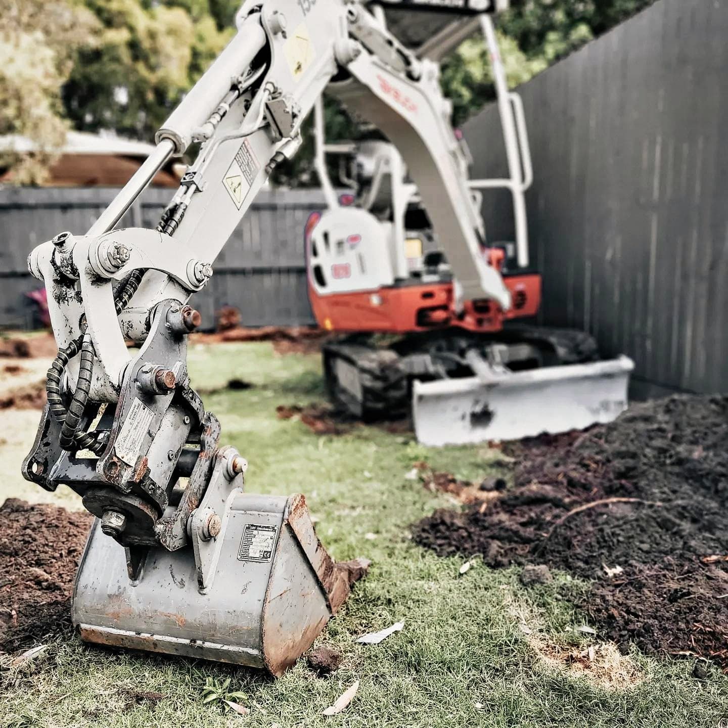 Machinery and mulch during a garden clearing project